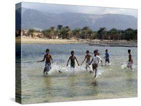 Children Enjoy a Boat Race in a Lagoon at Qalansiah, an Important Fishing Village in the Northwest-Nigel Pavitt-Stretched Canvas