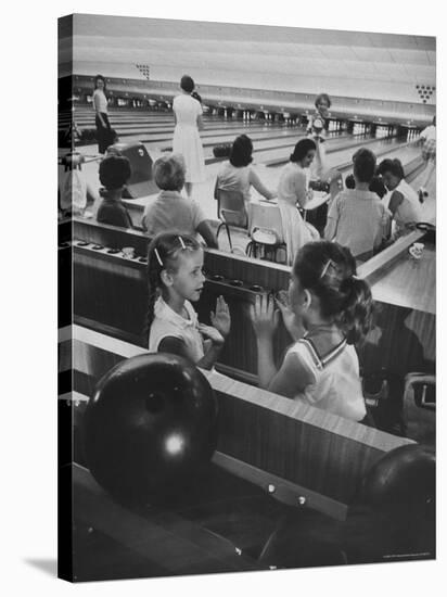 Children Entertaining Themselves While Their Mothers Compete in Bowling League-Stan Wayman-Stretched Canvas