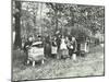 Children Feeding Bees for the Winter, Shrewsbury House Open Air School, London, 1909-null-Mounted Premium Photographic Print