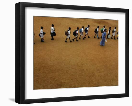 Children Follow Their Teacher as They Head Back to School for the First Time after the Tsunami-null-Framed Photographic Print