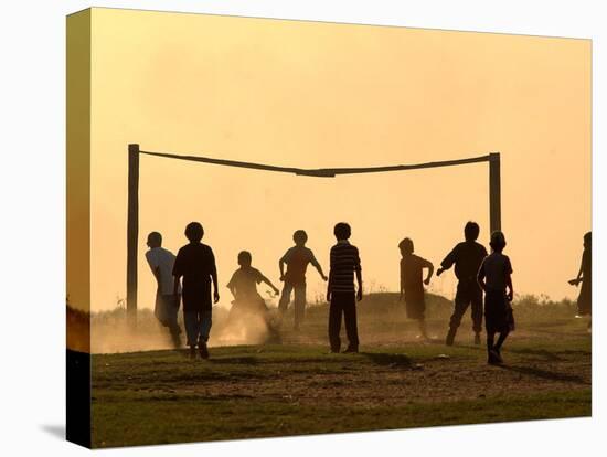 Children from the Toba Qom Ethnic Group Play Soccer During Indegenous Indian Day Celebration-null-Stretched Canvas