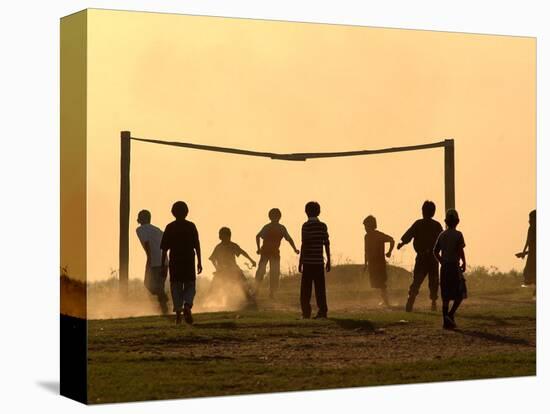 Children from the Toba Qom Ethnic Group Play Soccer During Indegenous Indian Day Celebration-null-Stretched Canvas