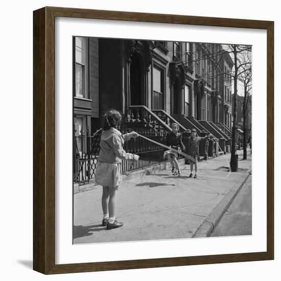 Children Jump Roping on Sidewalk Next to Brooklyn Brownstones, NY, 1949-Ralph Morse-Framed Photographic Print