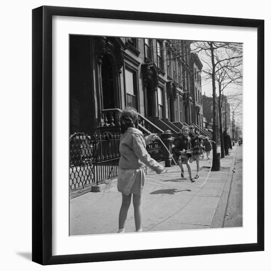 Children Jump Roping on Sidewalk Next to Brooklyn Brownstones, NY, 1949-Ralph Morse-Framed Photographic Print