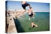 Children Jumping into the Sea from Stone Jetty-Felipe Rodriguez-Stretched Canvas