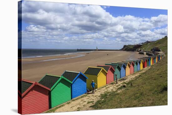 Children Kick Football Near Colourful Beach Huts Above West Cliff Beach-Eleanor Scriven-Stretched Canvas