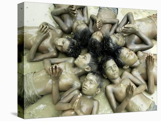 Children Lie in Sludge as a Ritual to Induce Rain in Nari Bari, India-null-Stretched Canvas