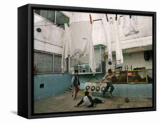 Children of an Immigrant Family from Bolivia Play Soccer at Their House-null-Framed Stretched Canvas