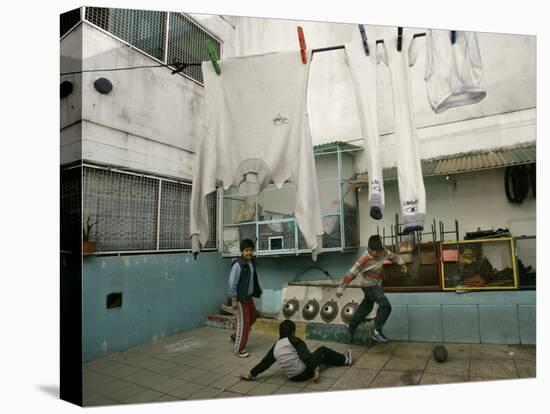 Children of an Immigrant Family from Bolivia Play Soccer at Their House-null-Stretched Canvas