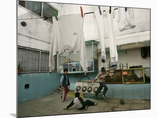 Children of an Immigrant Family from Bolivia Play Soccer at Their House-null-Mounted Photographic Print