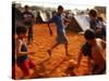 Children Play Soccer Between Tents Placed on a Dusty Lot-null-Stretched Canvas