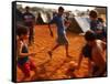 Children Play Soccer Between Tents Placed on a Dusty Lot-null-Framed Stretched Canvas