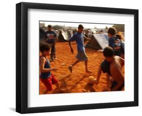 Children Play Soccer Between Tents Placed on a Dusty Lot-null-Framed Photographic Print