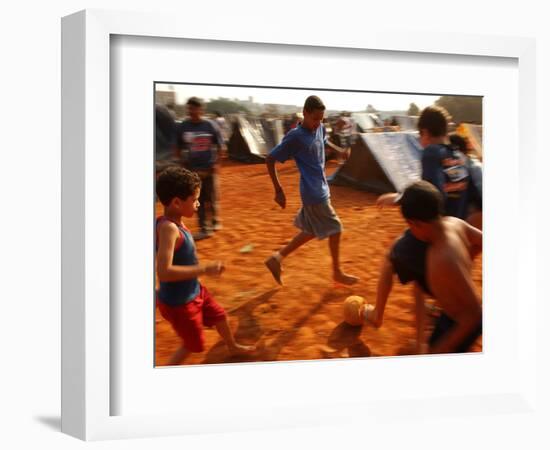 Children Play Soccer Between Tents Placed on a Dusty Lot-null-Framed Photographic Print