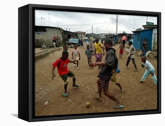 Children Play Soccer in an Impoverished Street in Lagos, Nigeria-null-Framed Stretched Canvas