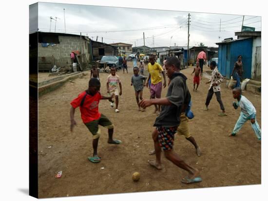 Children Play Soccer in an Impoverished Street in Lagos, Nigeria-null-Stretched Canvas