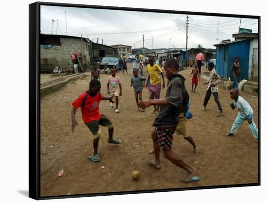 Children Play Soccer in an Impoverished Street in Lagos, Nigeria-null-Framed Stretched Canvas