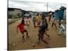 Children Play Soccer in an Impoverished Street in Lagos, Nigeria-null-Stretched Canvas