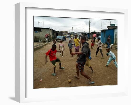 Children Play Soccer in an Impoverished Street in Lagos, Nigeria-null-Framed Premium Photographic Print