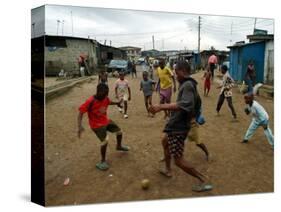 Children Play Soccer in an Impoverished Street in Lagos, Nigeria-null-Stretched Canvas