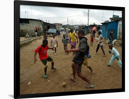 Children Play Soccer in an Impoverished Street in Lagos, Nigeria-null-Framed Photographic Print