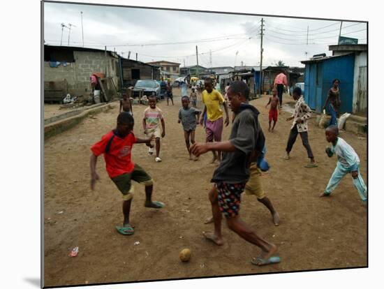 Children Play Soccer in an Impoverished Street in Lagos, Nigeria-null-Mounted Photographic Print