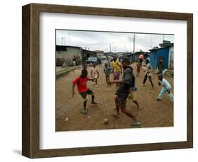 Children Play Soccer in an Impoverished Street in Lagos, Nigeria-null-Framed Photographic Print