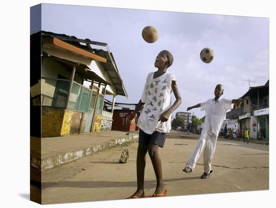 Children Play Soccer on a Street-null-Stretched Canvas