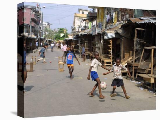 Children Play Soccer on One of the Streets of the Business District of Lagos-null-Stretched Canvas