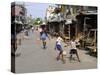 Children Play Soccer on One of the Streets of the Business District of Lagos-null-Stretched Canvas