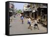 Children Play Soccer on One of the Streets of the Business District of Lagos-null-Framed Stretched Canvas