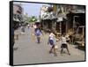 Children Play Soccer on One of the Streets of the Business District of Lagos-null-Framed Stretched Canvas