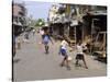 Children Play Soccer on One of the Streets of the Business District of Lagos-null-Stretched Canvas