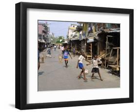 Children Play Soccer on One of the Streets of the Business District of Lagos-null-Framed Photographic Print