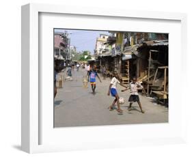 Children Play Soccer on One of the Streets of the Business District of Lagos-null-Framed Photographic Print