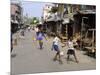 Children Play Soccer on One of the Streets of the Business District of Lagos-null-Mounted Photographic Print