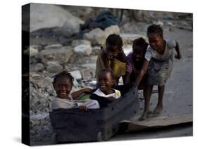 Children Play with a Suitcase Near a Camp for People Displaced by the Earthquake in Port-Au-Prince-null-Stretched Canvas