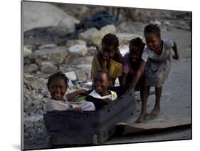 Children Play with a Suitcase Near a Camp for People Displaced by the Earthquake in Port-Au-Prince-null-Mounted Photographic Print