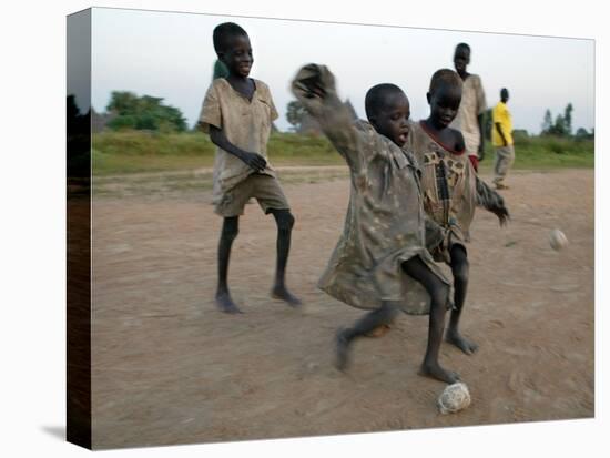 Children Play with Homemade Soccer Balls Made from Discarded Medical Gloves-null-Stretched Canvas