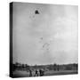 Children Playing with Kite That Releases Toys While in the Air-Bernard Hoffman-Stretched Canvas
