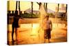 Children Playing with Water Fountains in Battery Park at Sunset,-Sabine Jacobs-Stretched Canvas