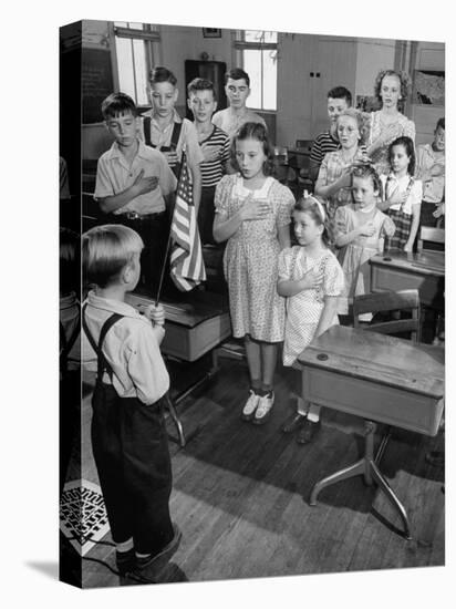 Children Reciting the Pledge of Allegiance as a Boy Holds the Us Flag in their Classroom-Bernard Hoffman-Stretched Canvas