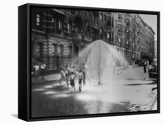 Children Running Around under Sprinkler in Street to Cool Off During Summer, in South Harlem-null-Framed Stretched Canvas