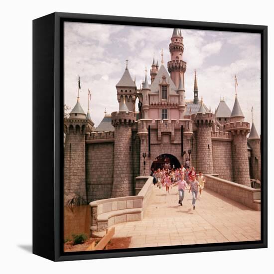 Children Running Through Gate of Sleeping Beauty's Castle at Walt Disney's Theme Park, Disneyland-Allan Grant-Framed Stretched Canvas