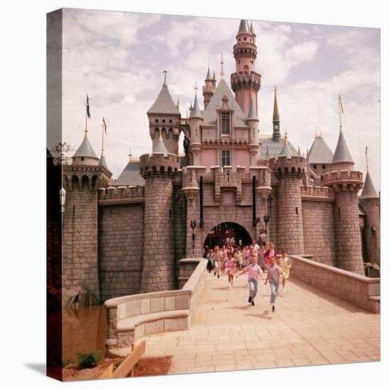 Children Running Through Gate of Sleeping Beauty's Castle at Walt Disney's Theme Park, Disneyland-Allan Grant-Stretched Canvas