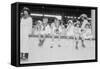 Children Sit on Wall in Front of Stands at the Ballpark and Eat Ice Cream Cones.-null-Framed Stretched Canvas
