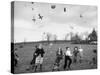 Children Trying to Catch Toys That Were Released by a Kite in the Air-Bernard Hoffman-Stretched Canvas