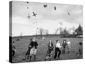 Children Trying to Catch Toys That Were Released by a Kite in the Air-Bernard Hoffman-Stretched Canvas