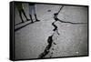 Children Walk Past a Crack Caused by the Earthquake in a Street in Port-Au-Prince-Carlos Barria-Framed Stretched Canvas