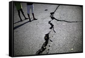 Children Walk Past a Crack Caused by the Earthquake in a Street in Port-Au-Prince-Carlos Barria-Framed Stretched Canvas